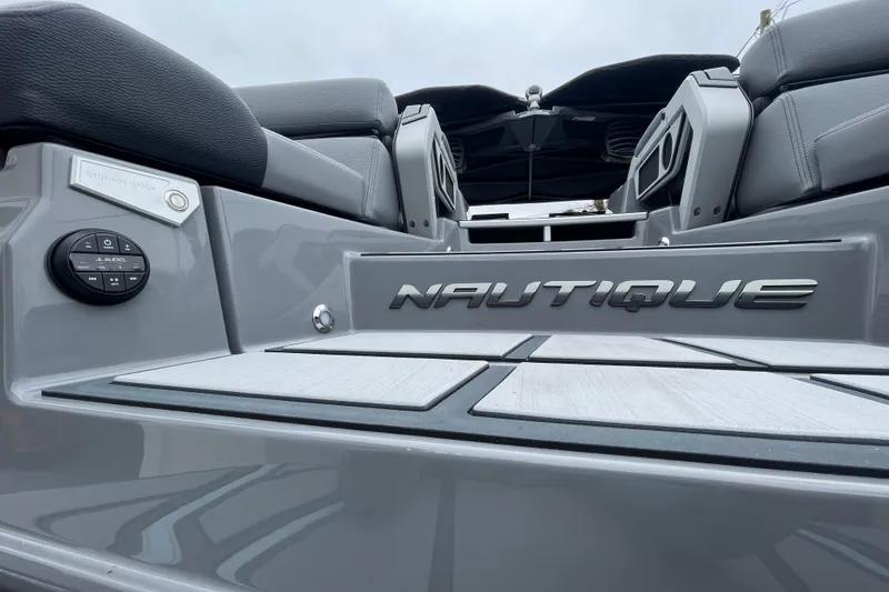 Slide: The Image of 2025 Nautique Super Air Nautique G23 Paragon boat interior, featuring sleek design and audio controls. - 12
