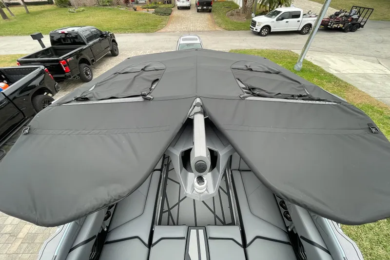 Slide: The Image of 2025 Nautique Super Air Nautique G23 Paragon with black cover, parked outdoors. - 16