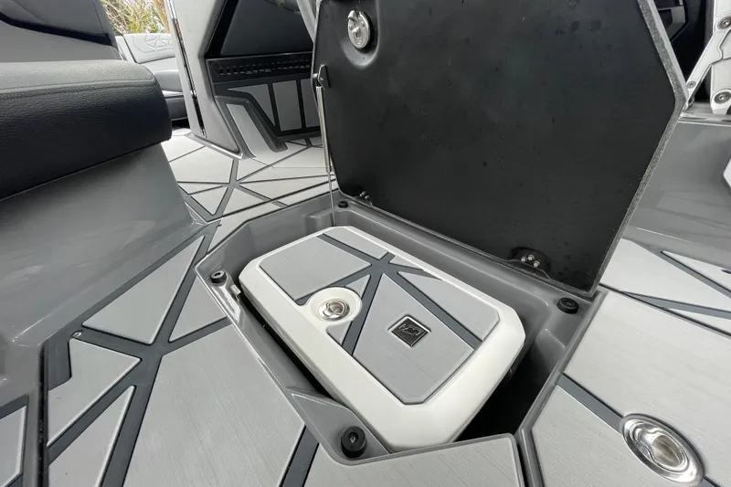 Slide: The Image of 2025 Nautique Super Air Nautique G23 Paragon interior storage compartment, open with sleek design. - 21
