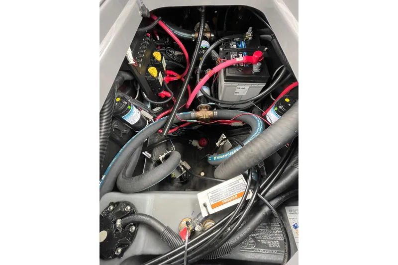 Slide: The Image of Engine compartment of 2025 Nautique Super Air Nautique G23 Paragon with visible wiring and components. - 22