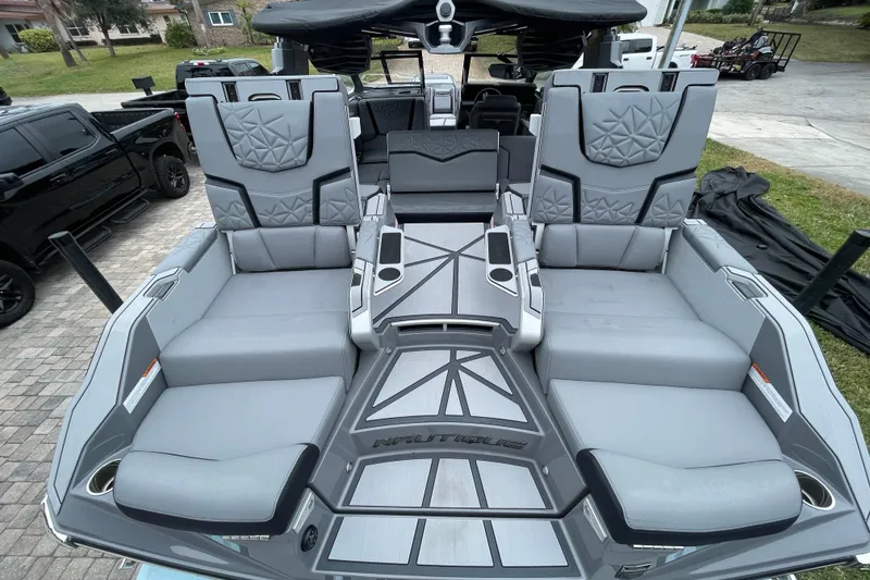 Slide: The Image of 2025 Nautique Super Air Nautique G23 Paragon interior with luxurious gray seating and modern design. - 26