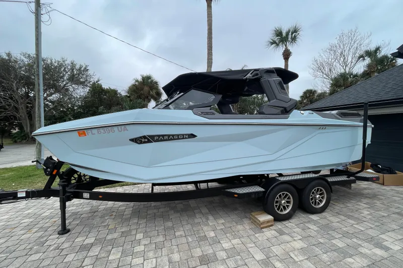 Slide: The Image of 2025 Nautique Super Air Nautique G23 Paragon boat on trailer, parked outdoors. - 3