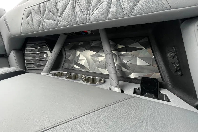 Slide: The Image of Interior of 2025 Nautique Super Air Nautique G23 Paragon with geometric design and cup holders. - 31