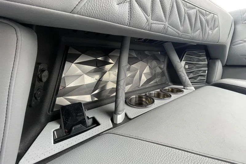Slide: The Image of 2025 Nautique Super Air Nautique G23 Paragon interior with geometric design and cup holders. - 32