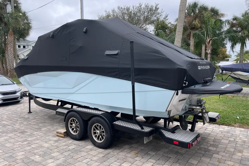 Slide: The Image of 2025 Nautique Super Air Nautique G23 Paragon boat covered on trailer. - 35
