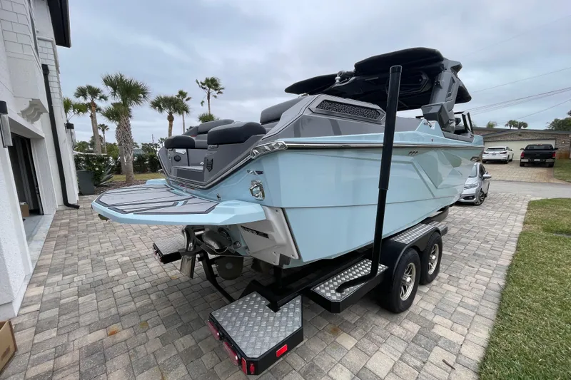 Slide: The Image of 2025 Nautique Super Air Nautique G23 Paragon boat on trailer, parked on driveway. - 6