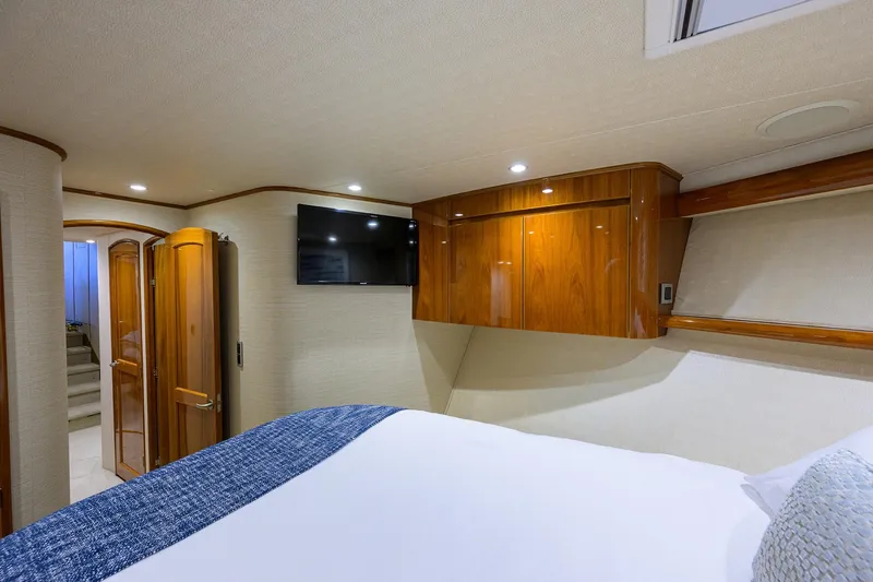 Slide: The Image of Luxurious cabin interior of 2015 Viking 62 Convertible yacht with cozy bed and wooden cabinetry. - 19