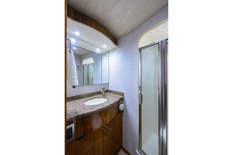 Slide: The Image of Luxurious cabin interior of 2015 Viking 62 Convertible yacht with wood finishes and TV. - 22