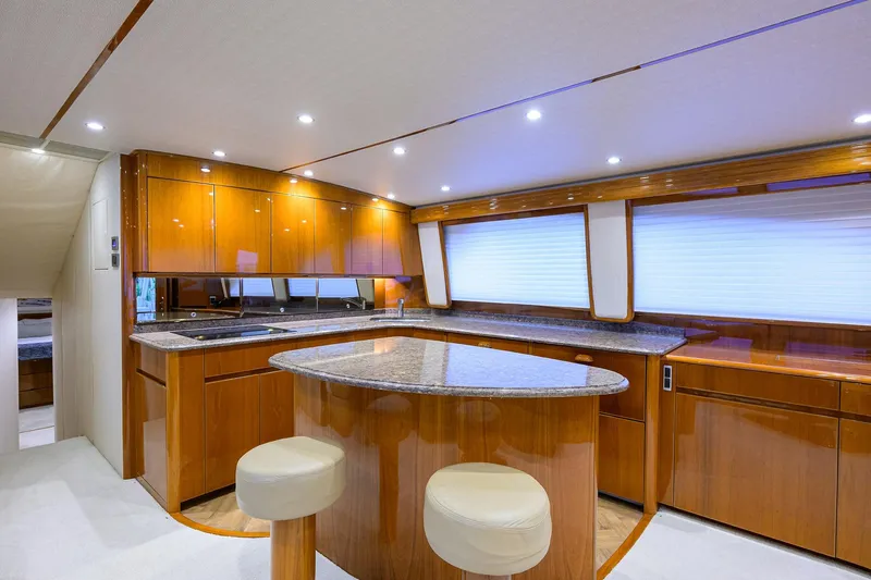 Slide: The Image of Bunk beds in 2015 Viking 62 Convertible yacht cabin with wooden finish and colorful pillows. - 27