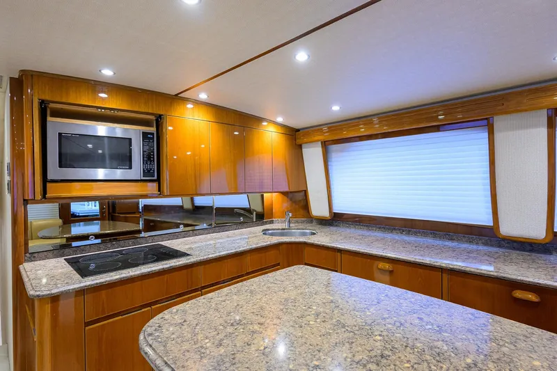 Slide: The Image of Bunk beds in 2015 Viking 62 Convertible yacht cabin with wooden finish and tropical pillows. - 29