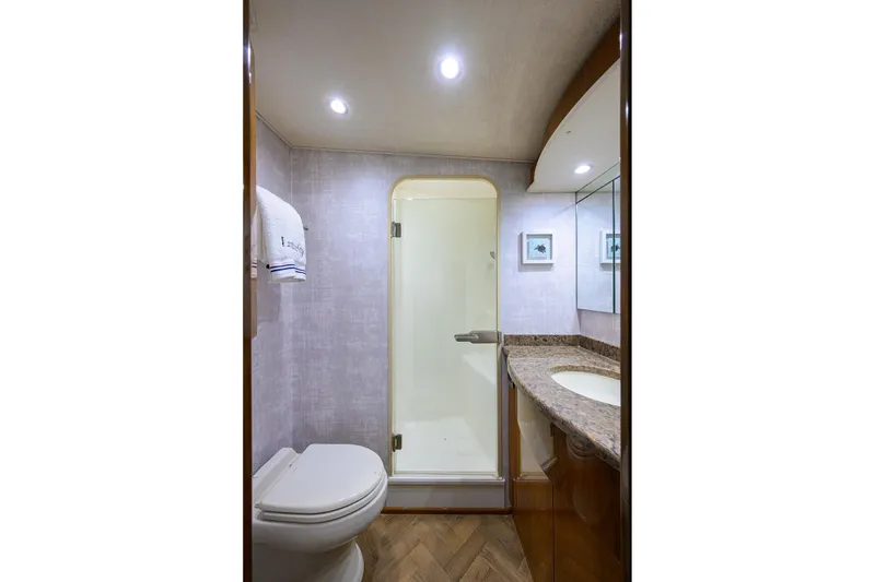 Slide: The Image of Luxurious bedroom interior of 2015 Viking 62 Convertible yacht with elegant wood finishes. - 43