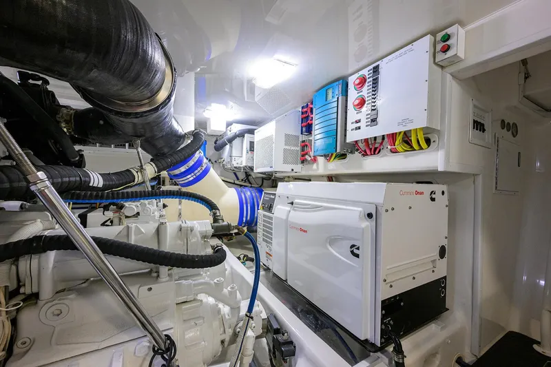 Slide: The Image of Engine room of 2015 Viking 62 Convertible yacht with CAT filters and fire extinguisher. - 60
