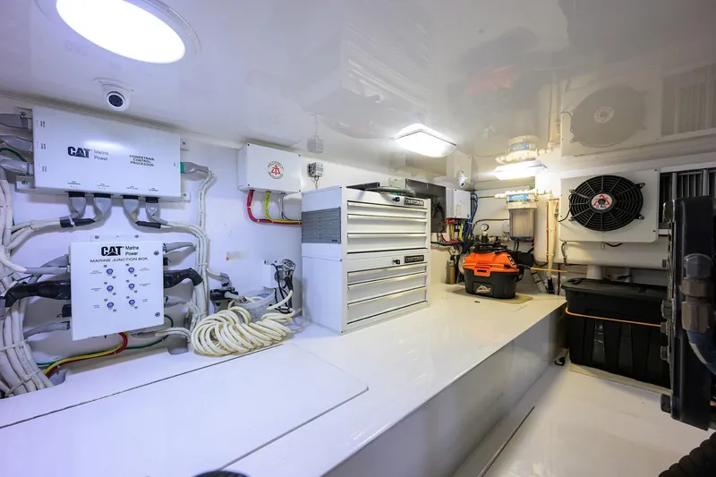 Slide: The Image of Engine room of 2015 Viking 62 Convertible yacht, featuring ventilation and machinery systems. - 64
