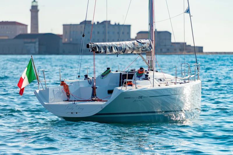 The Image of Italia Yachts 9.98 sailboat, 2026 model, on calm waters with Italian flag. - 0