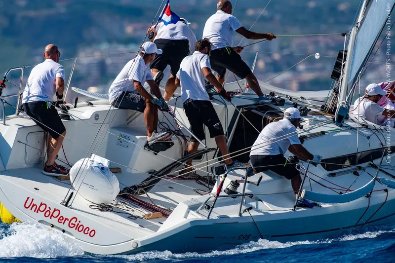 Slide: The Image of Crew sailing Italia Yachts 9.98, 2026 model, during a competitive regatta. - 10