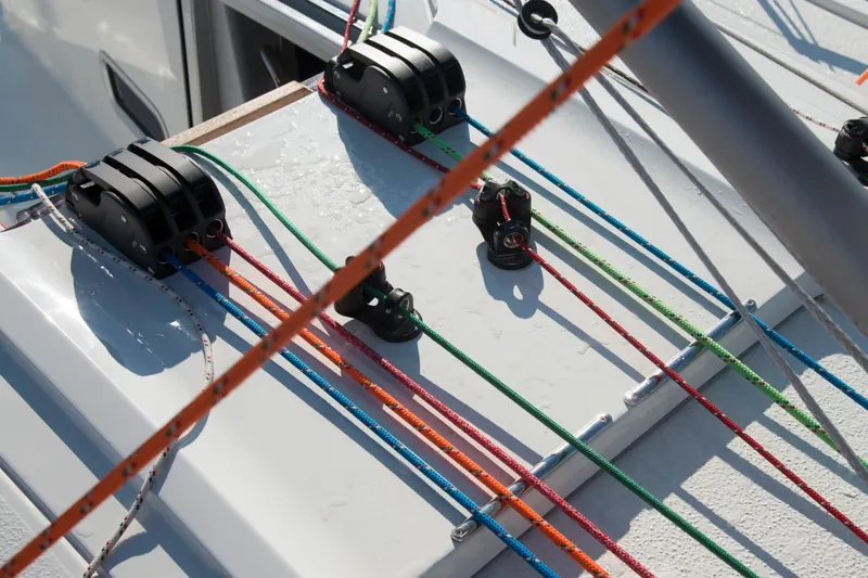 Slide: The Image of Deck rigging on 2026 Italia Yachts 9.98, featuring colorful ropes and pulleys. - 12