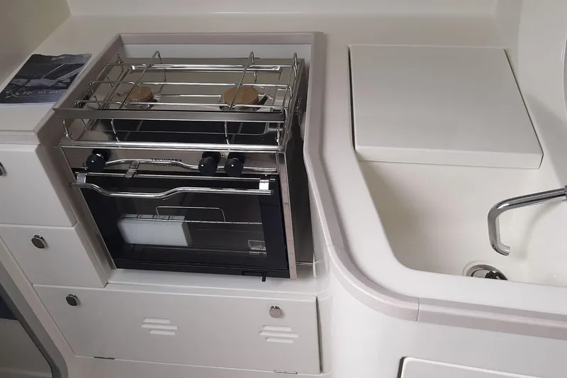 Slide: The Image of Italia Yachts 9.98 (2026) yacht kitchen with stove and sink. - 23