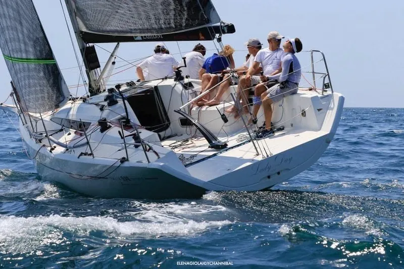 Slide: The Image of Italia Yachts 9.98 sailing with crew, 2026 model, on open sea. - 4