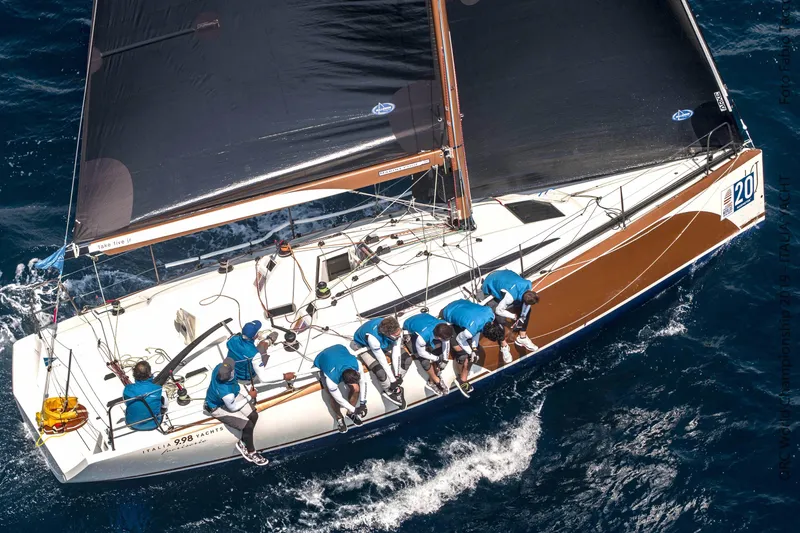 Slide: The Image of Italia Yachts 9.98 sailing with crew, 2026 model, on open sea. - 6