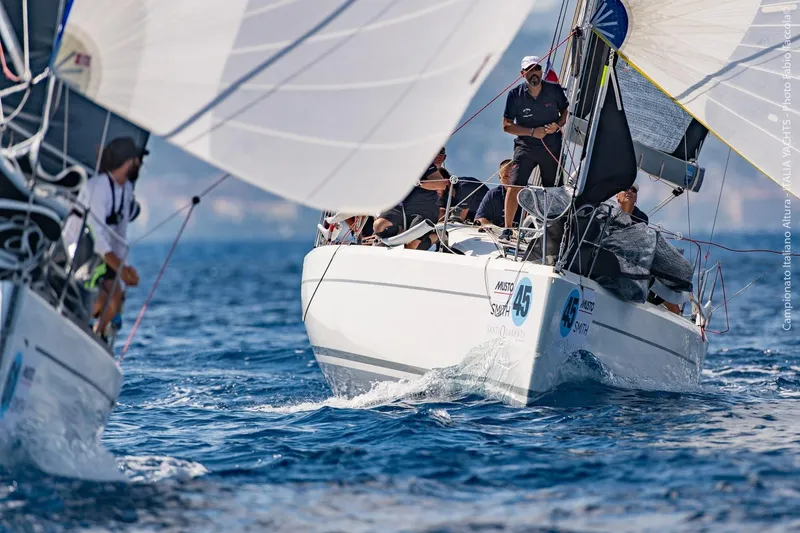 Slide: The Image of Italia Yachts 9.98 sailing in a competitive race, 2026 model. - 8