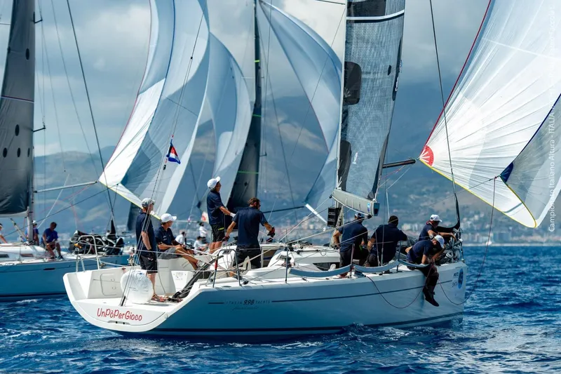 Slide: The Image of Sailing race featuring Italia Yachts 9.98, 2026 model, with crew navigating blue waters. - 9