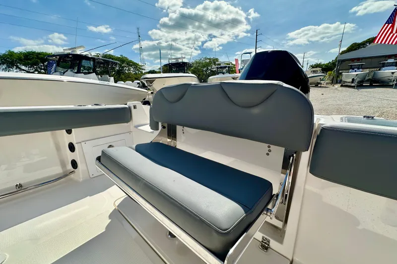 Slide: The Image of 2024 NauticStar 222 Offshore boat interior with cushioned seating and storage. - 11