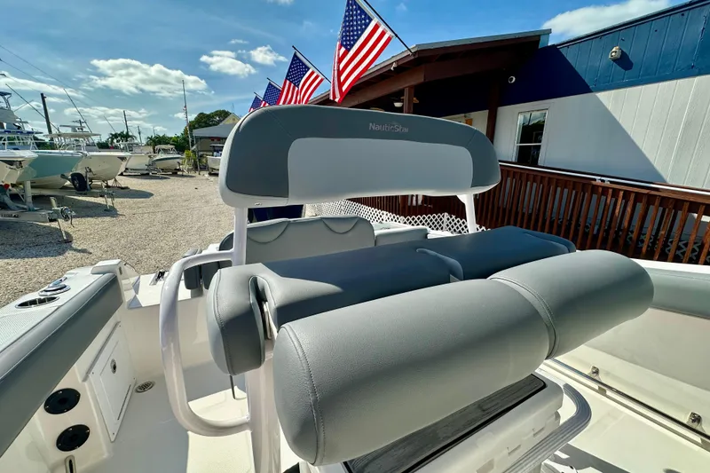 Slide: The Image of 2024 NauticStar 222 Offshore boat interior with American flags in the background. - 9