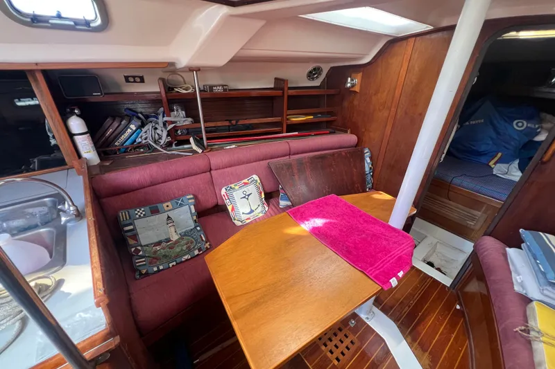 Slide: The Image of Interior of 1987 Hunter Legend 37 sailboat with cozy seating and nautical decor. - 12
