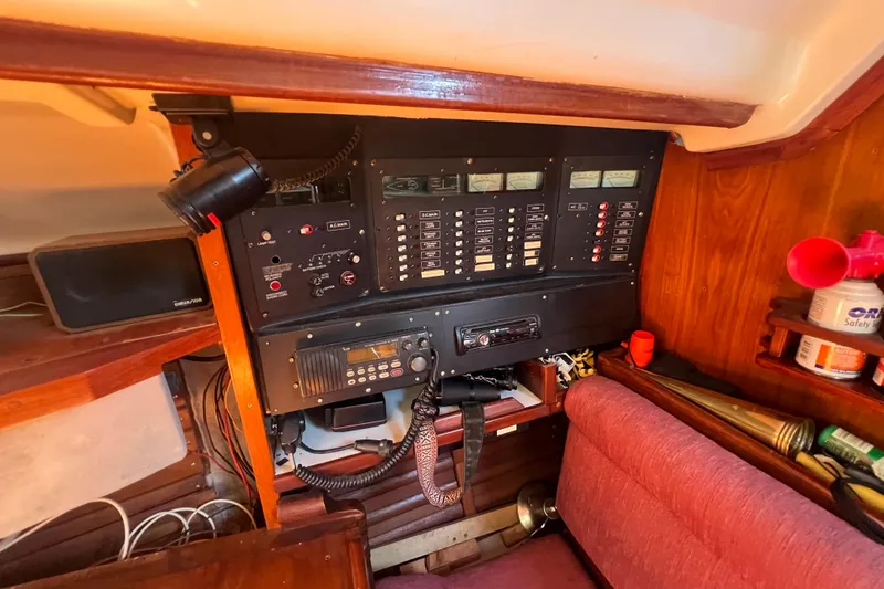Slide: The Image of Electrical control panel inside 1987 Hunter Legend 37 sailboat cabin with radio and seating. - 13