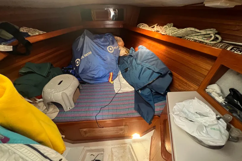 Slide: The Image of Cozy cabin interior of 1987 Hunter Legend 37 sailboat with storage and bedding. - 14