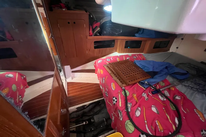 Slide: The Image of Interior of 1987 Hunter Legend 37 sailboat with colorful bedding and wooden cabinetry. - 16