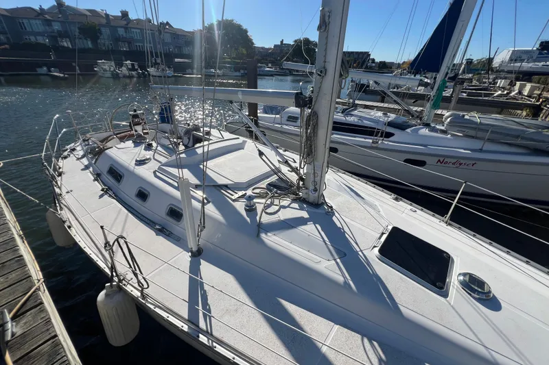 Slide: The Image of 1987 Hunter Legend 37 sailboat docked in a sunny marina. - 5