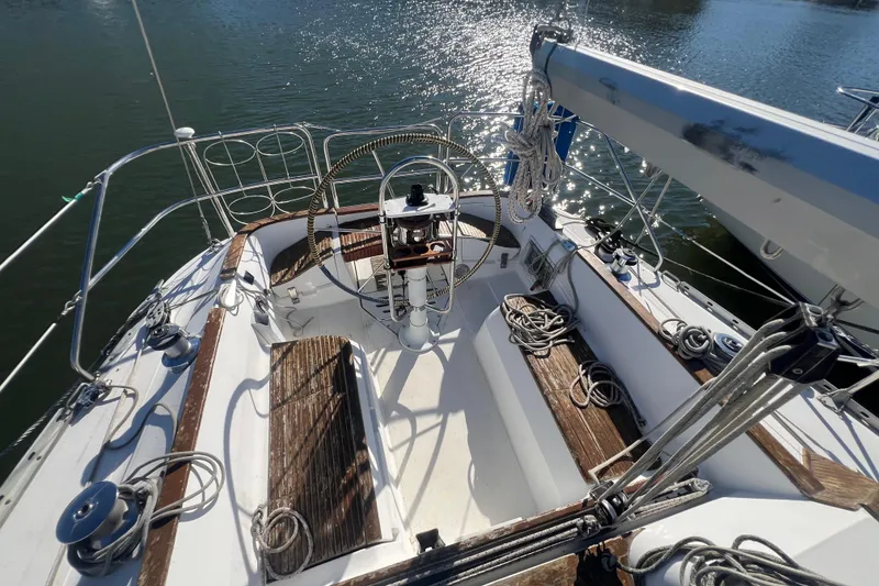 Slide: The Image of 1987 Hunter Legend 37 sailboat cockpit with wooden benches and steering wheel. - 6