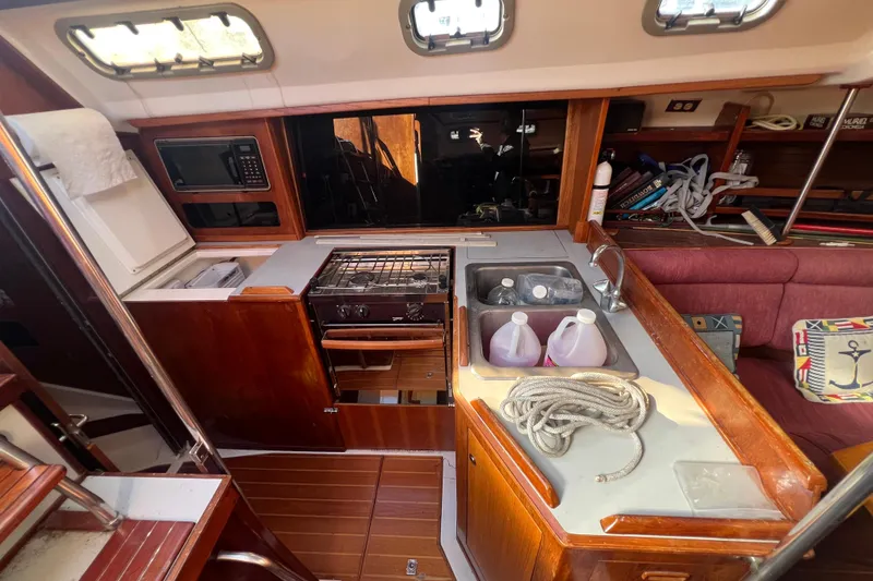 Slide: The Image of Interior of 1987 Hunter Legend 37 sailboat with kitchen and seating area. - 9
