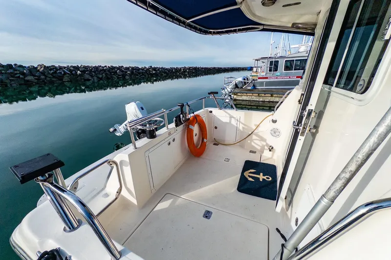 Slide: The Image of Outboard motor on Aspen C90 boat, 2012 model, reflected in calm water. - 10