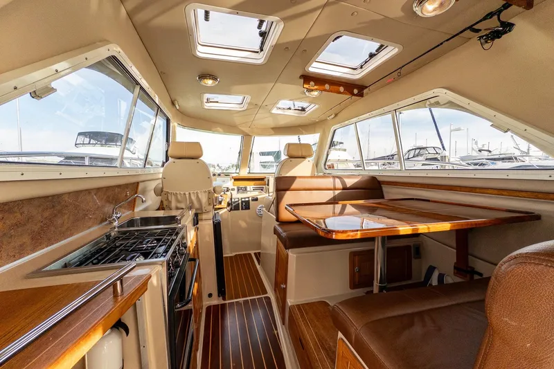 Slide: The Image of Compact kitchen in 2012 Aspen C90 boat with stove, sink, and wooden cabinets. - 21