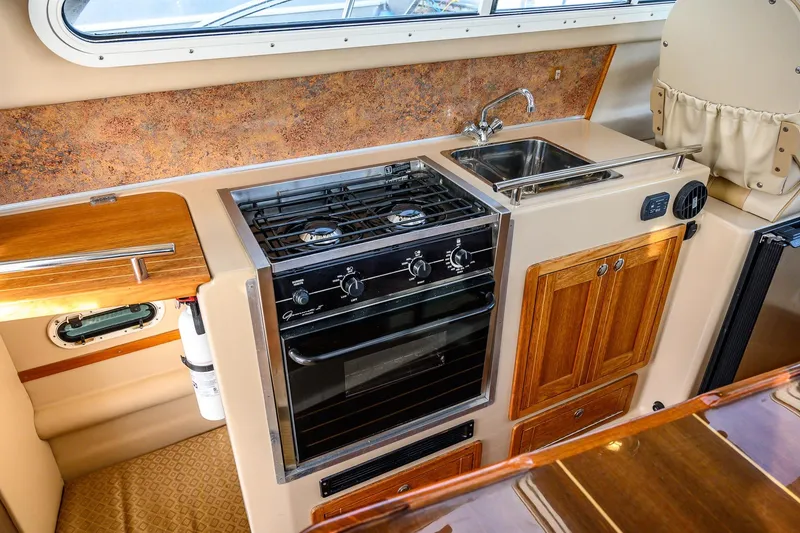 Slide: The Image of 2012 Aspen C90 interior cabin with cushioned sleeping area and wooden accents. - 22