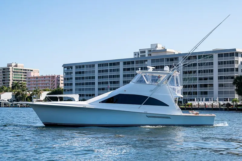 The Image of 1999 Ocean Yachts 60 Convertible cruising near waterfront buildings. - 0