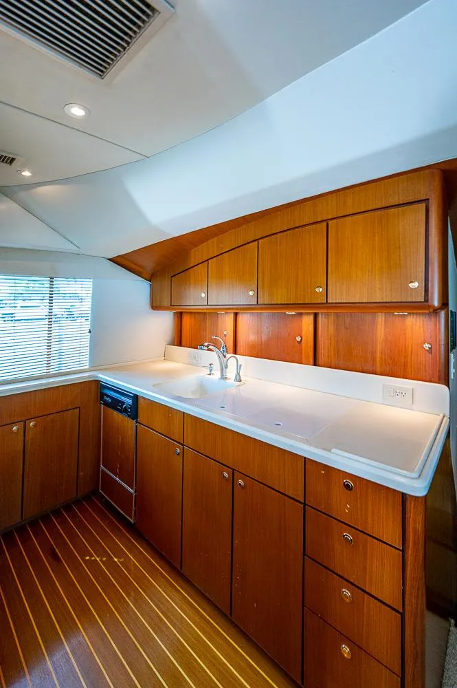 Slide: The Image of 1999 Ocean Yachts 60 Convertible kitchen with wooden cabinets and modern fixtures. - 21