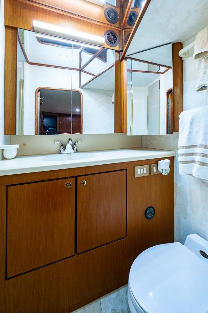 Slide: The Image of Luxurious bathroom in 1999 Ocean Yachts 60 Convertible, featuring wood cabinetry and modern fixtures. - 39