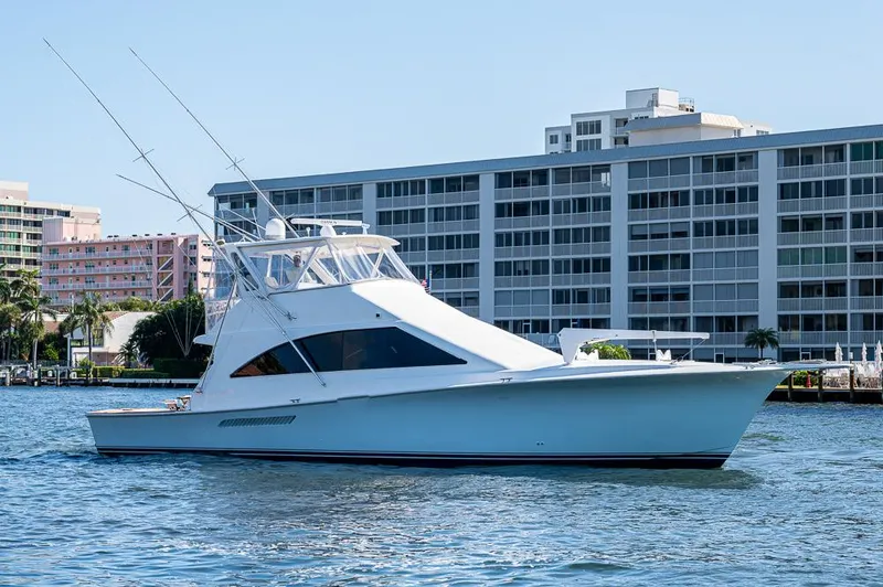 Slide: The Image of 1999 Ocean Yachts 60 Convertible cruising near waterfront buildings. - 7
