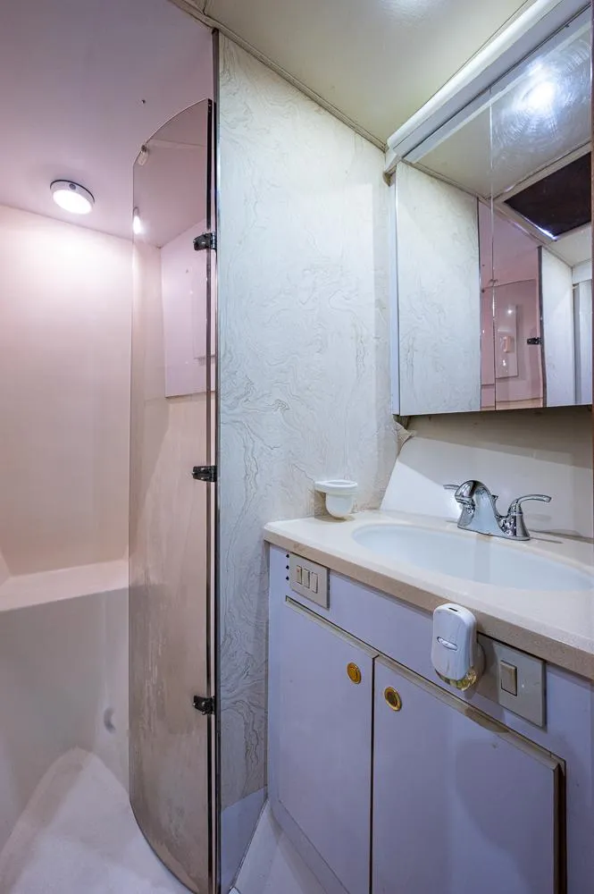 Slide: The Image of Bathroom interior of 1999 Ocean Yachts 60 Convertible with shower and vanity. - 28