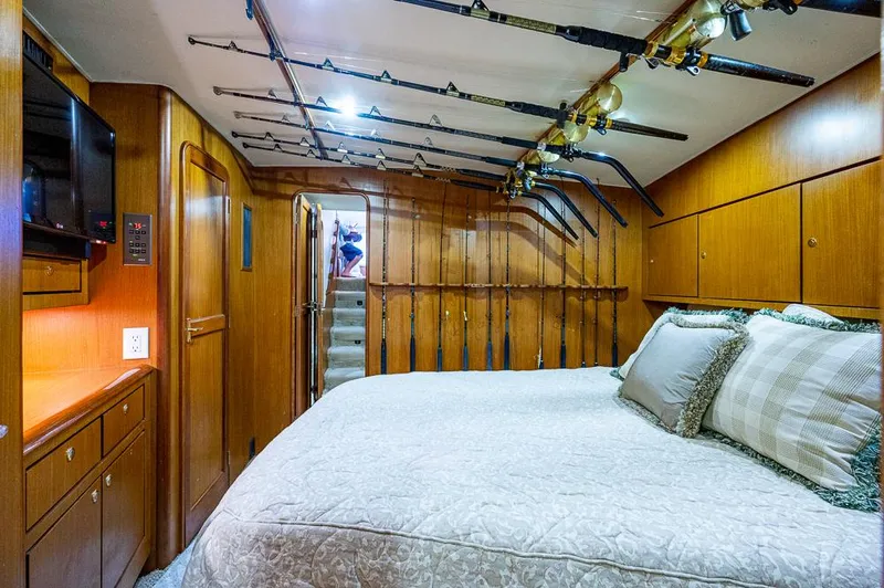 Slide: The Image of Luxurious cabin interior of 1999 Ocean Yachts 60 Convertible with fishing rods displayed. - 31