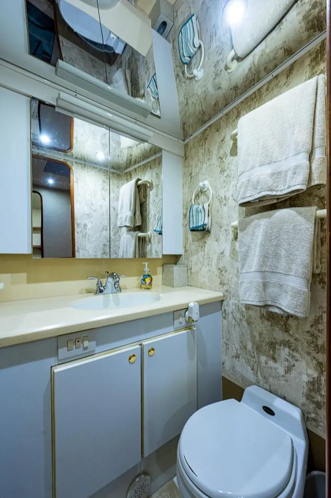 Slide: The Image of Luxurious bathroom in 1999 Ocean Yachts 60 Convertible, featuring elegant fixtures and ample storage. - 33