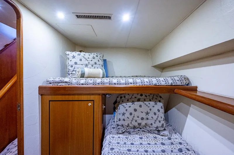 Slide: The Image of Bunk beds in 1999 Ocean Yachts 60 Convertible cabin with patterned bedding. - 36