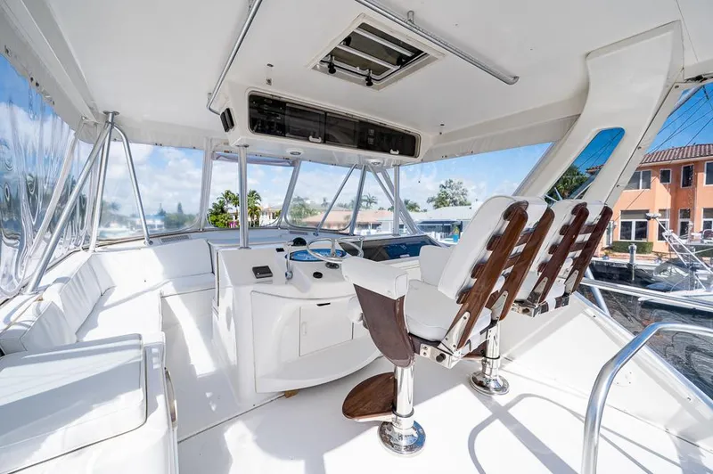 Slide: The Image of 1999 Ocean Yachts 60 Convertible yacht interior with helm and seating area. - 42