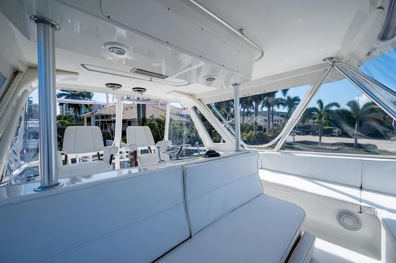 Slide: The Image of 1999 Ocean Yachts 60 Convertible interior with white seating and panoramic windows. - 48