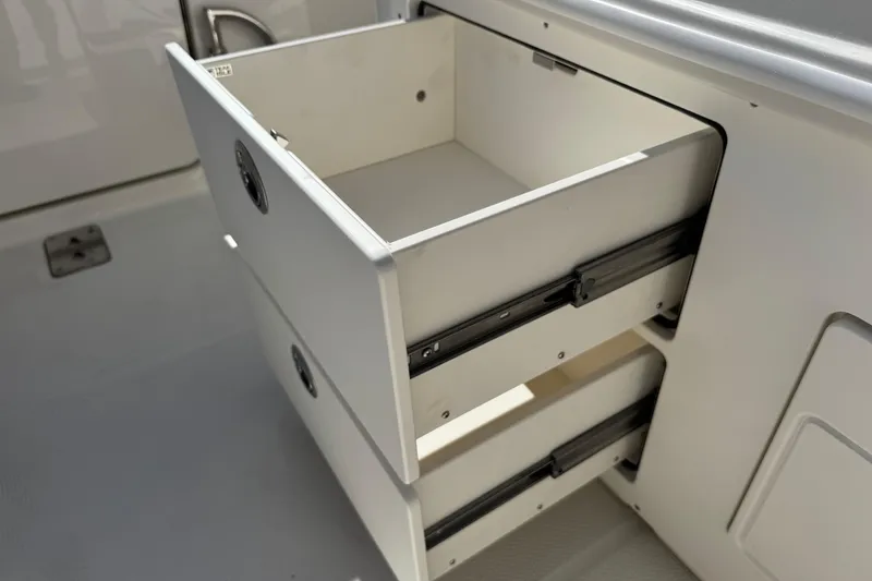 Slide: The Image of Open storage drawers on 2026 Sailfish 272 CC boat, showcasing interior design. - 12