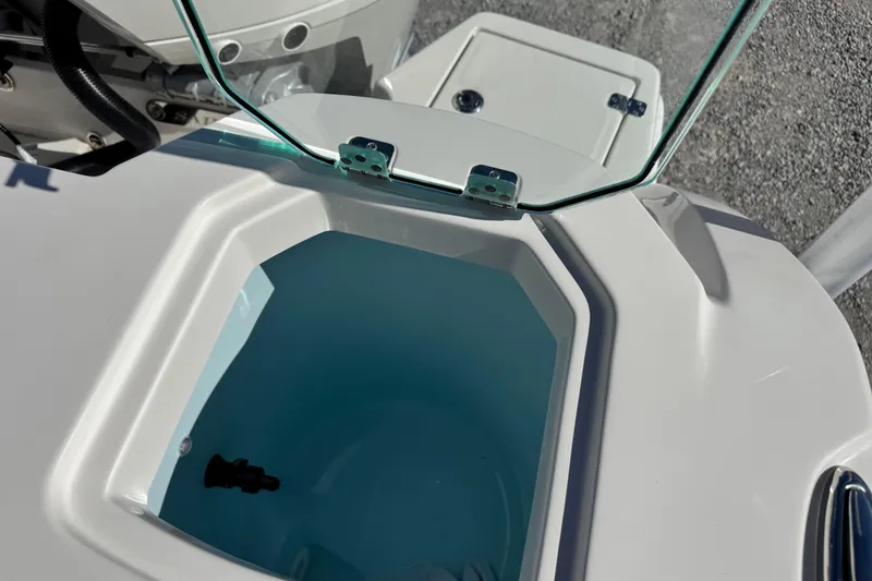 Slide: The Image of Open hatch on 2026 Sailfish 272 CC boat, revealing storage compartment. - 13