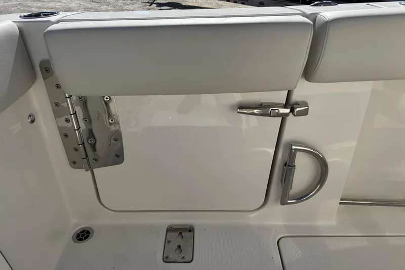 Slide: The Image of 2026 Sailfish 272 CC boat interior, featuring a sleek white door with stainless steel hardware. - 14